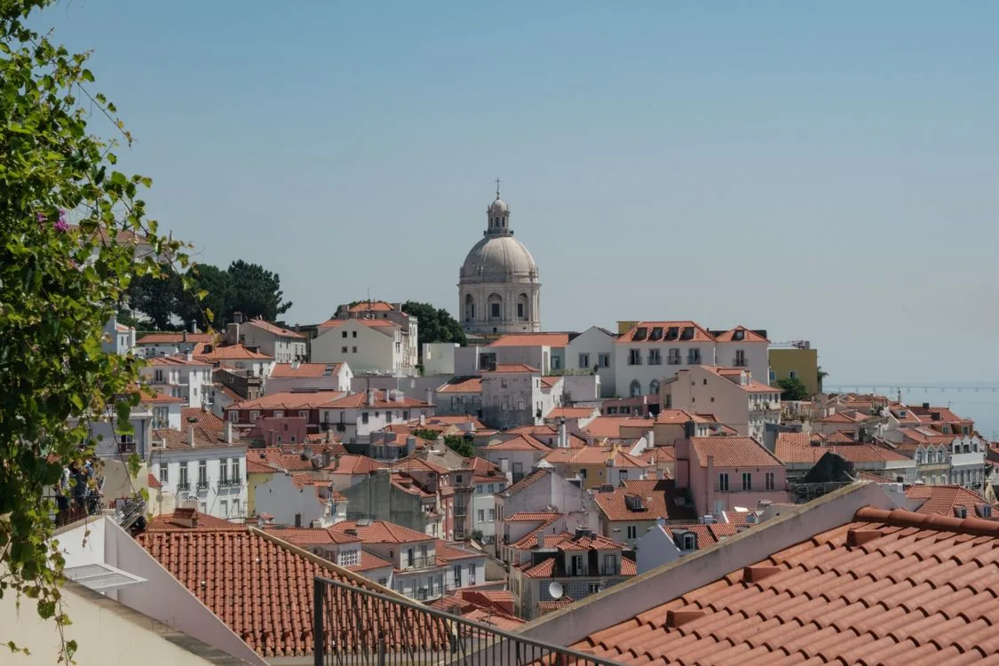 Red rooftops and a white dome above Lisbon